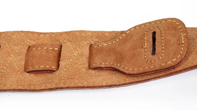 Strap tail fitted with a strap lock on a guitar strap button