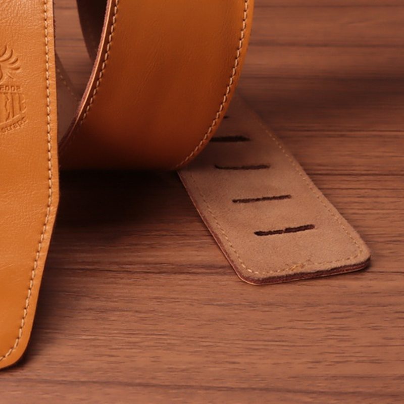 The suede-finish back of the tail, with the slots that set the length