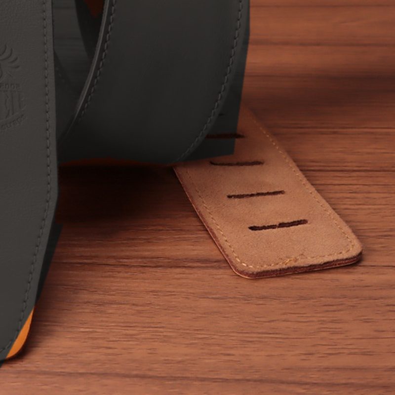 The suede-finish back of the tail beside the strap face, shown in black