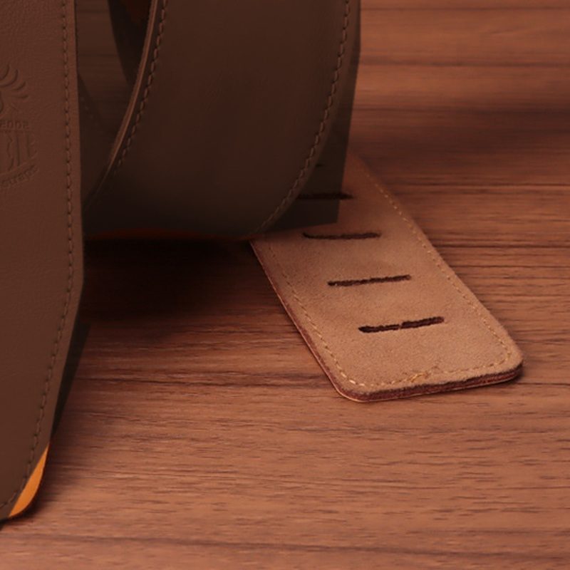 The suede-finish back of the tail beside the strap face, shown in dark brown