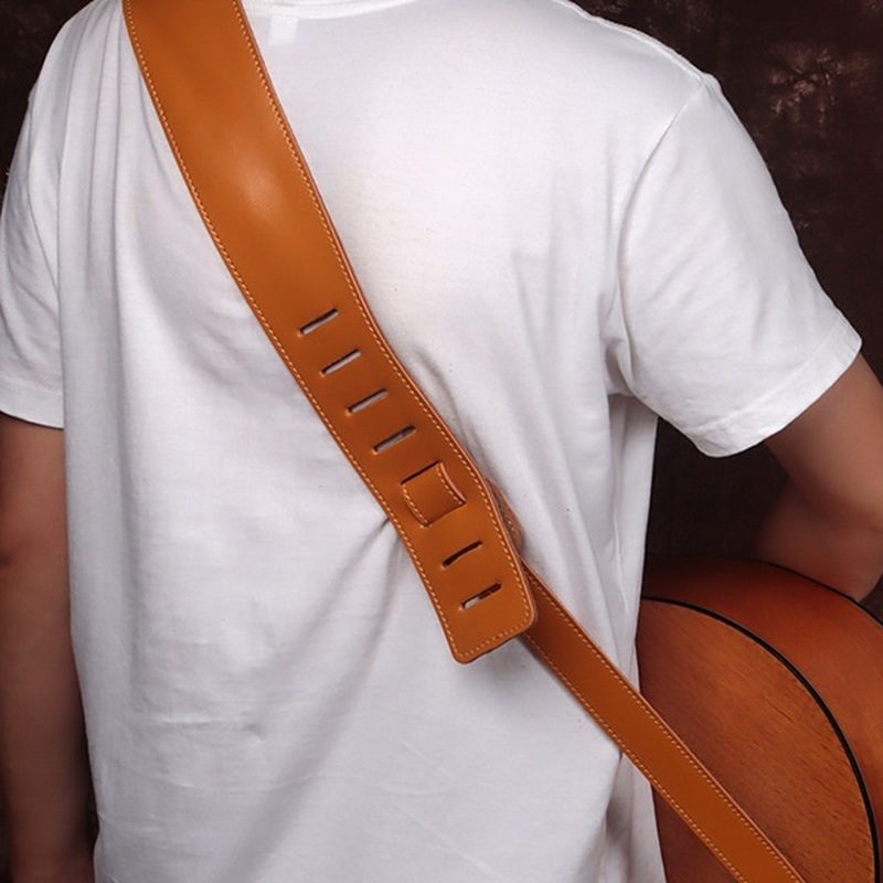 The strap worn over the shoulder, with the row of slots that sets the length