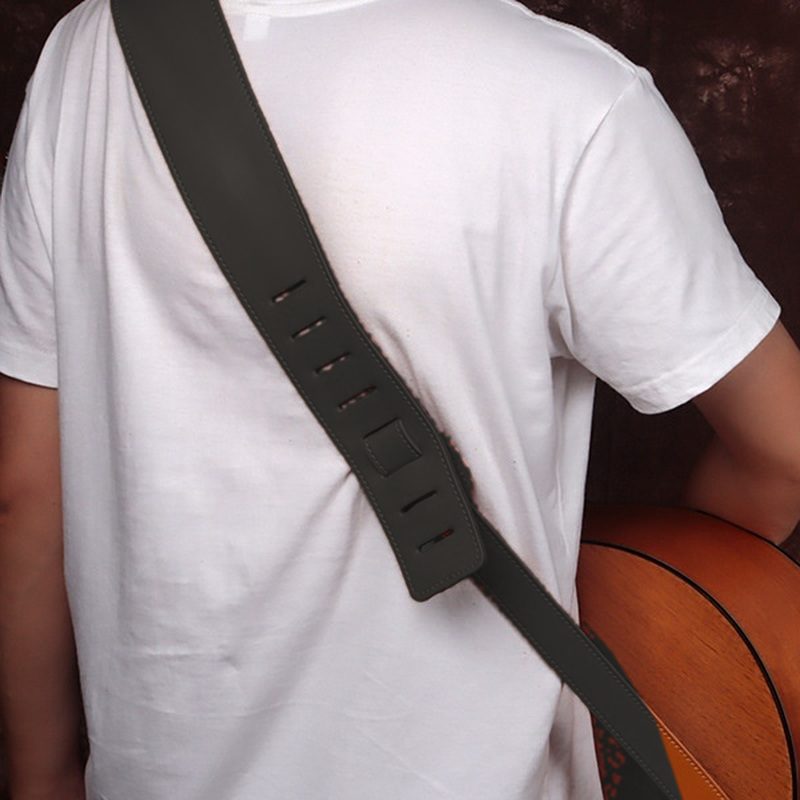 The strap worn over the shoulder, shown in black