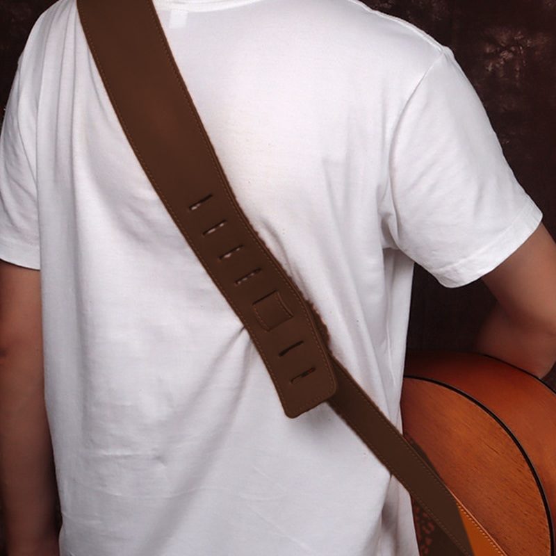 The strap worn over the shoulder, shown in dark brown